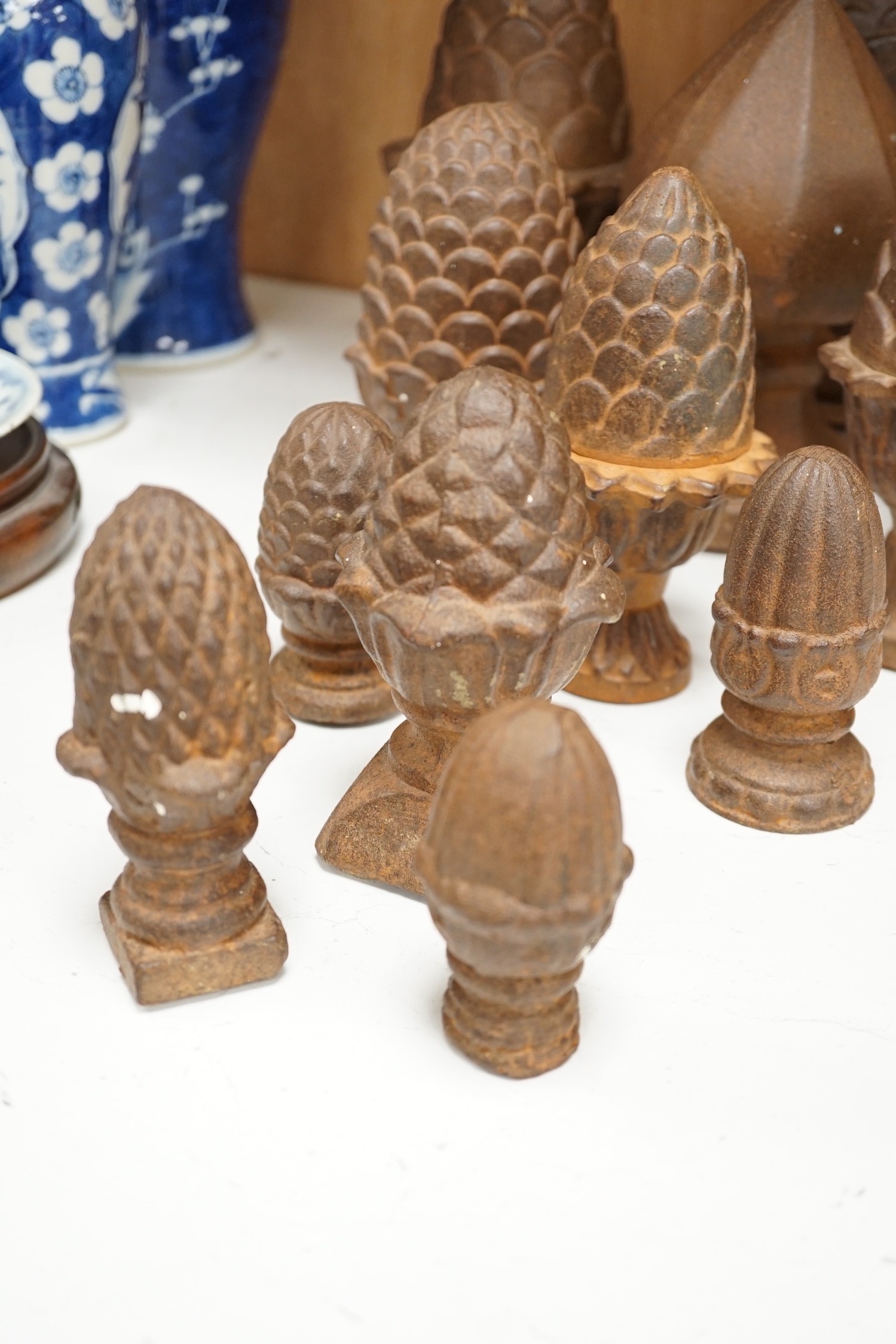 A group of cast iron finials, some with pine-cone decoration, tallest 21cm